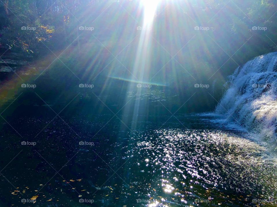 Mardis Mill waterfall with winter rainbow and sunlit spray