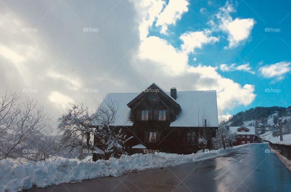 Wooden house covered with snow on Swiss Alps 