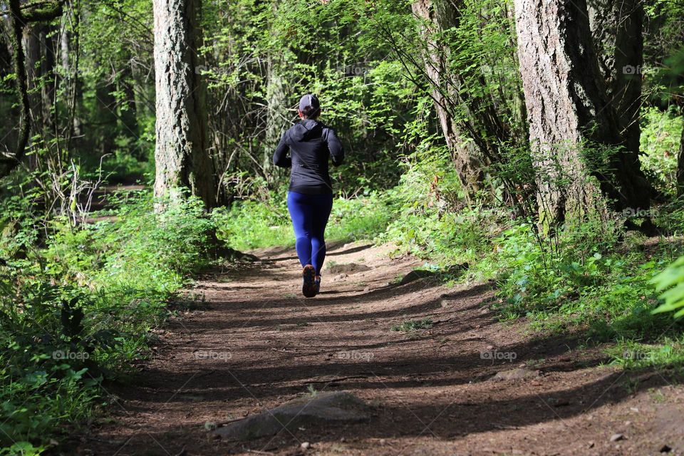 Woman running into the woods