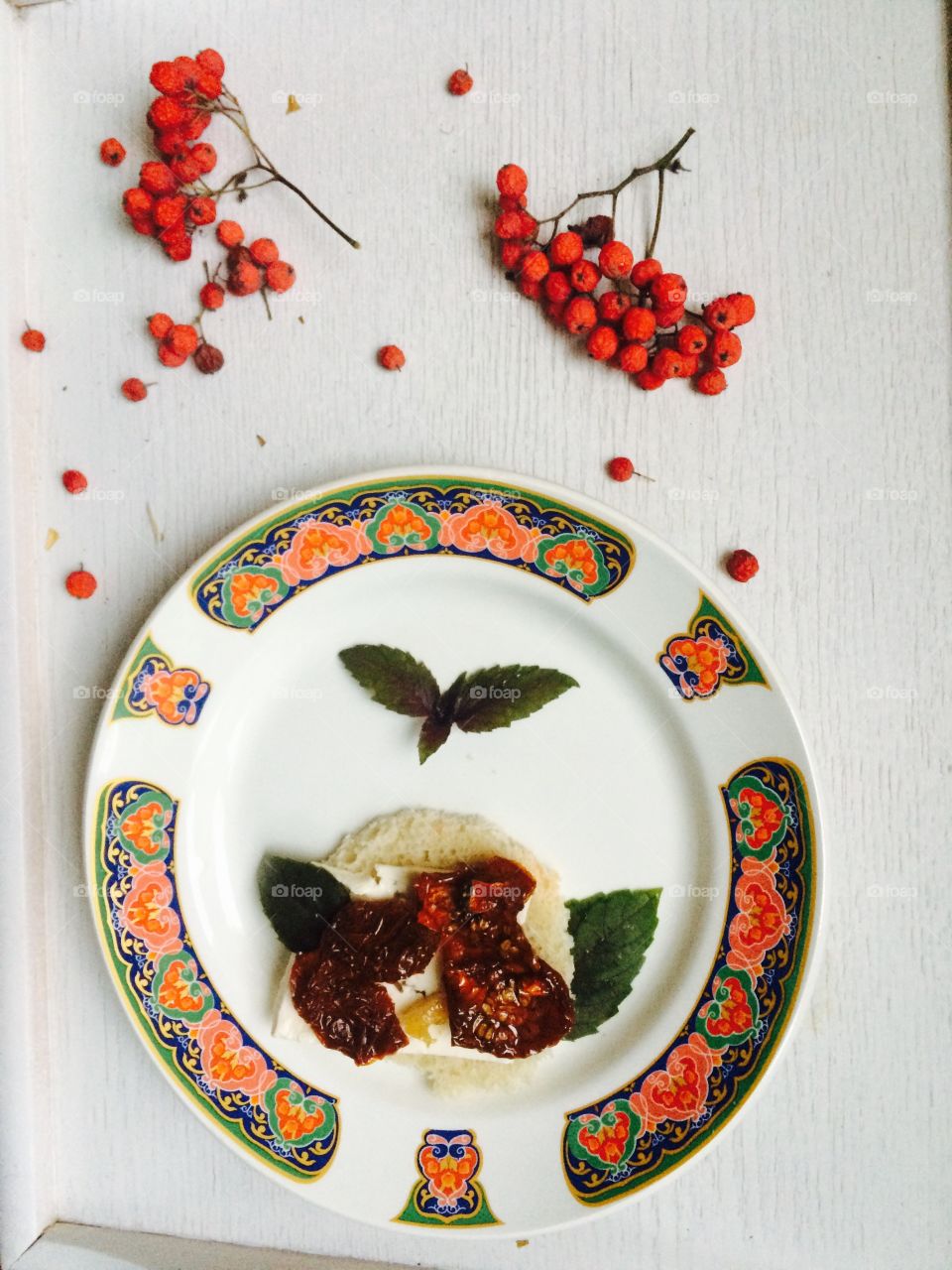 butterbread with cheese and fried tomatoes and basil leaves