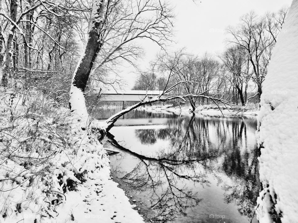 Winter days on the white river and the old potters covered bridge on a snowy day. 