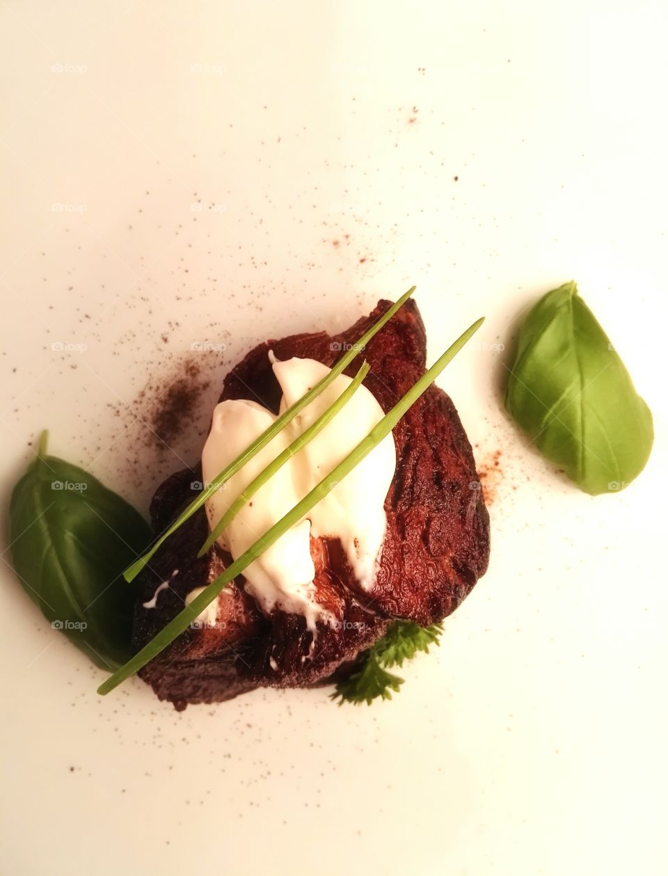 Steak with fresh herbs on a white background