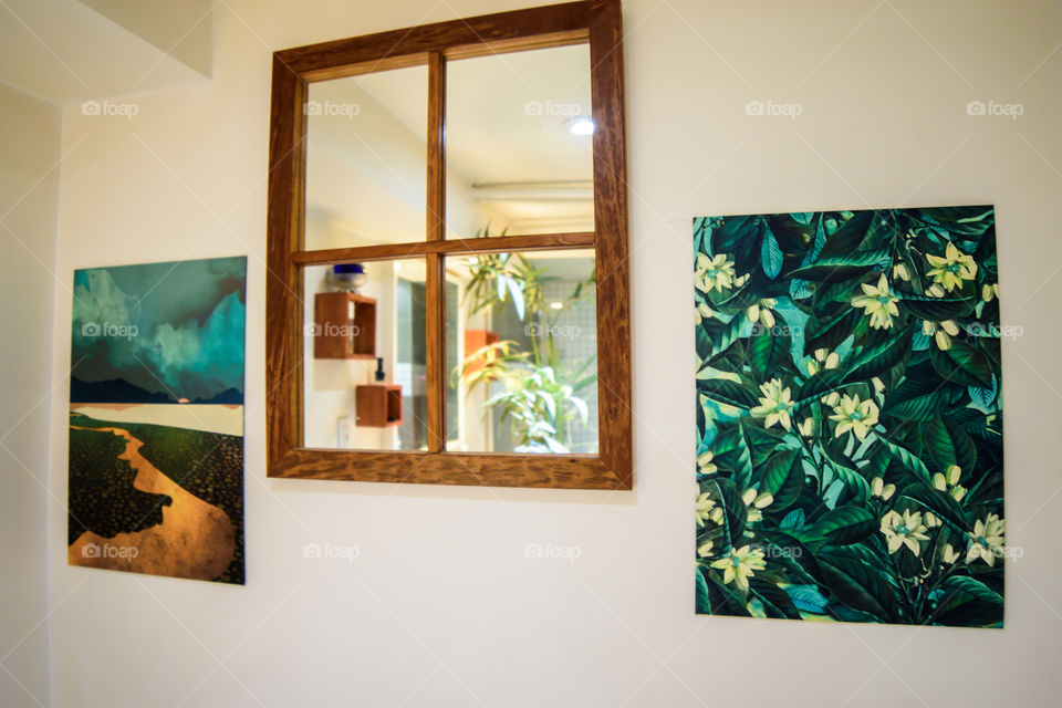 Displate art on wall in bathroom with mirror reflecting plants 