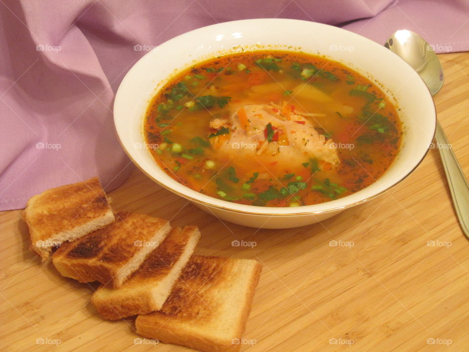 Chicken soup with green onion and toast bread