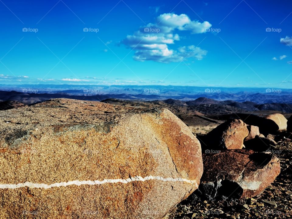 Wild rock in desert sharing its beauty with yhe blue sky.