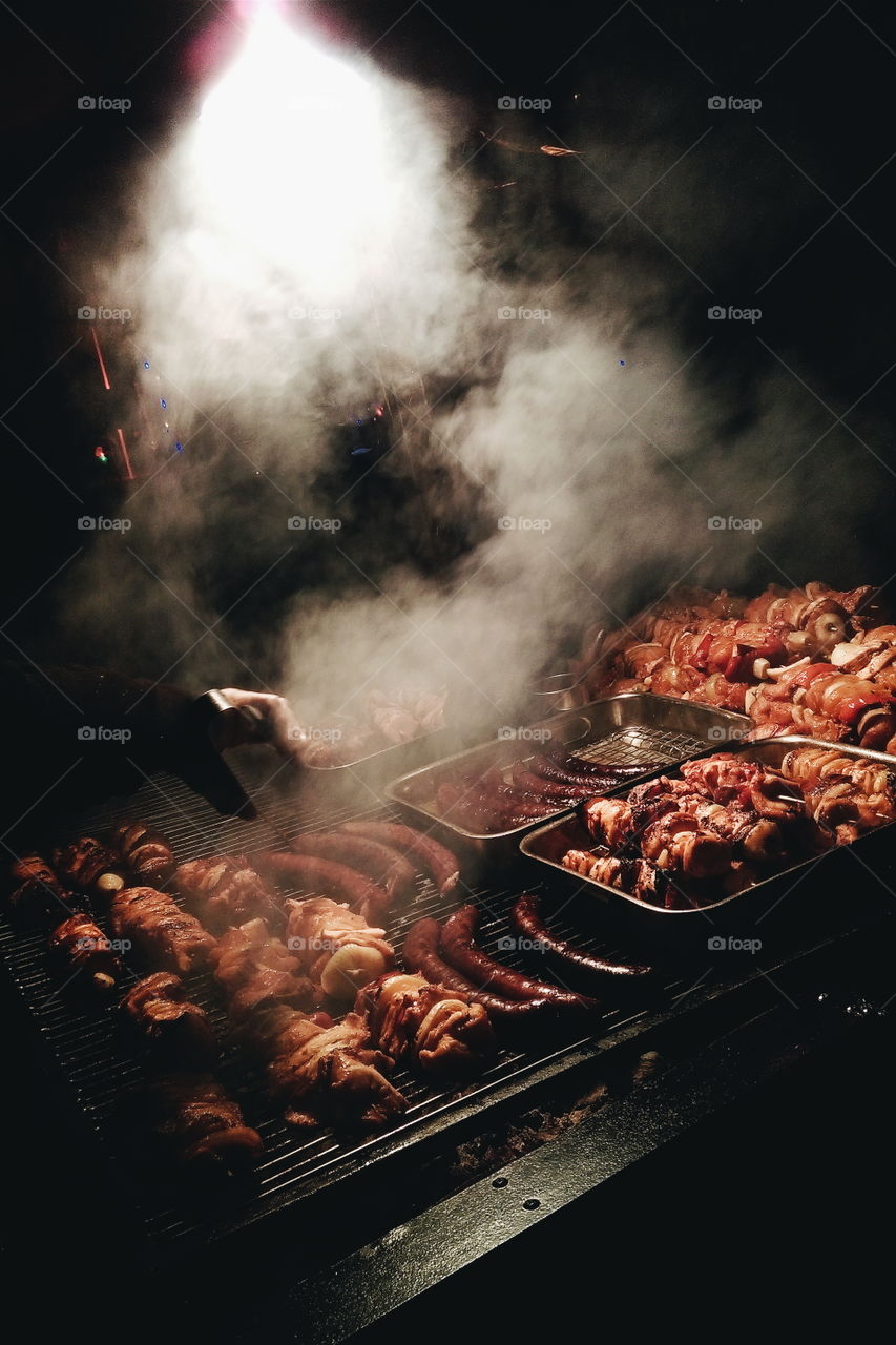 Assorted delicious grilled meat with vegetable over the coals on a barbecue