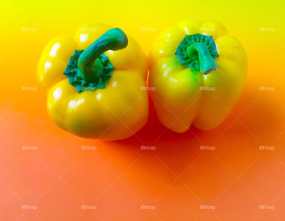 Bell peppers on yellow and orange background