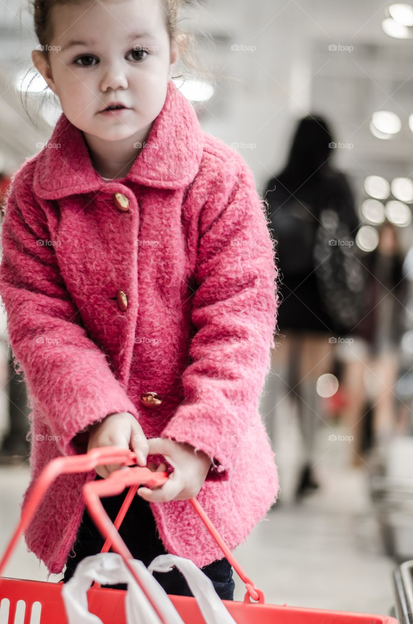 Little girl holding red basket