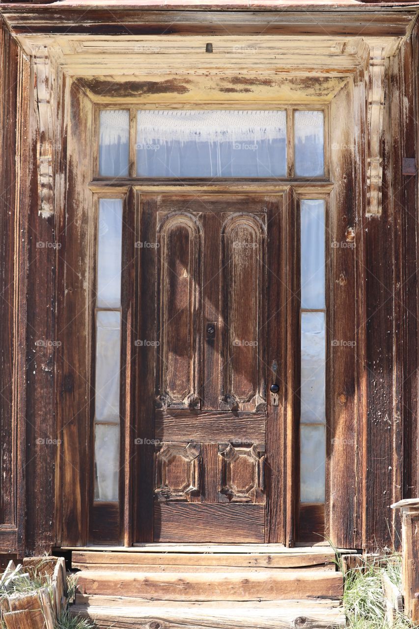 Old weathered wood door and entranceway from outside background 