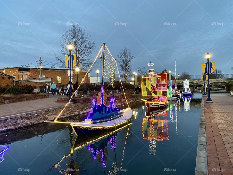Illuminated model boats on a canal during an annual event in Frederick Maryland