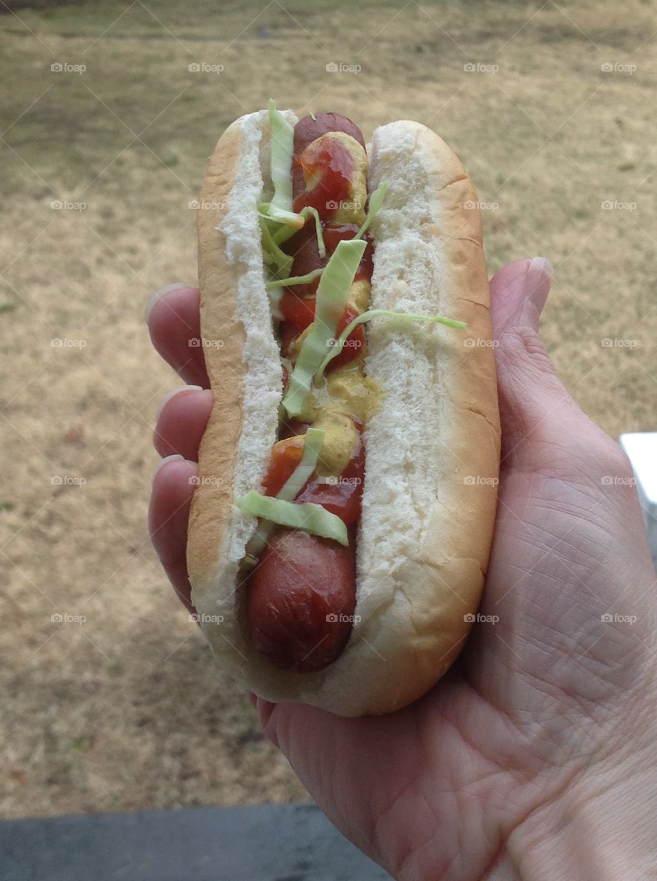 Holding a delicious looking hotdog.