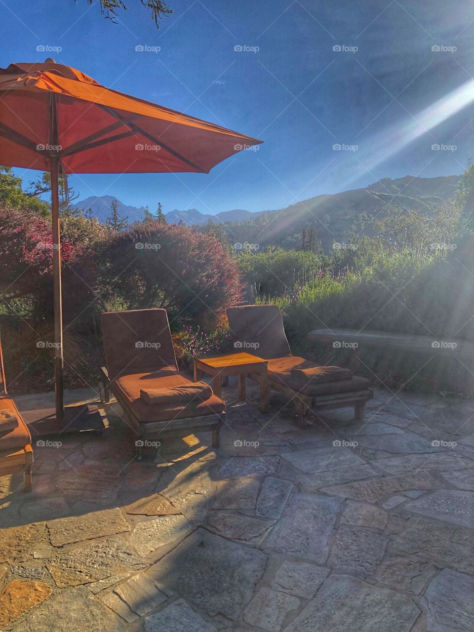 Secluded sun trap in big sur, California at the luxurious post ranch inn resort. Beautiful sun stream across the hills and onto two sun loungers