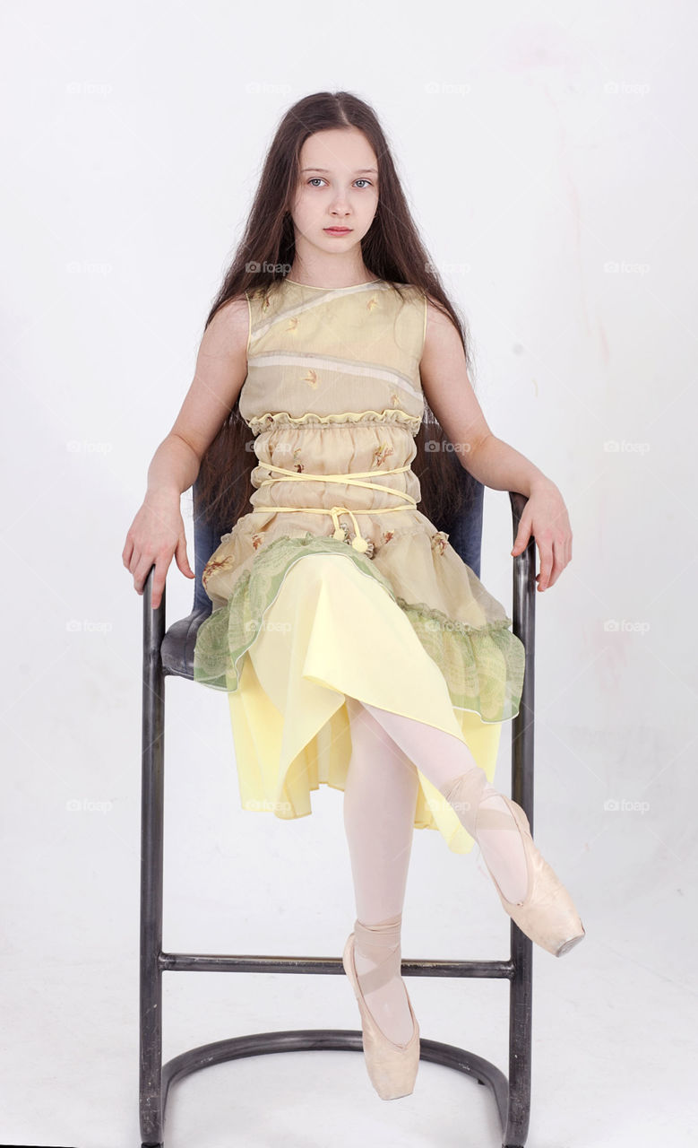 Ballerina girl in yellow and pointe shoes