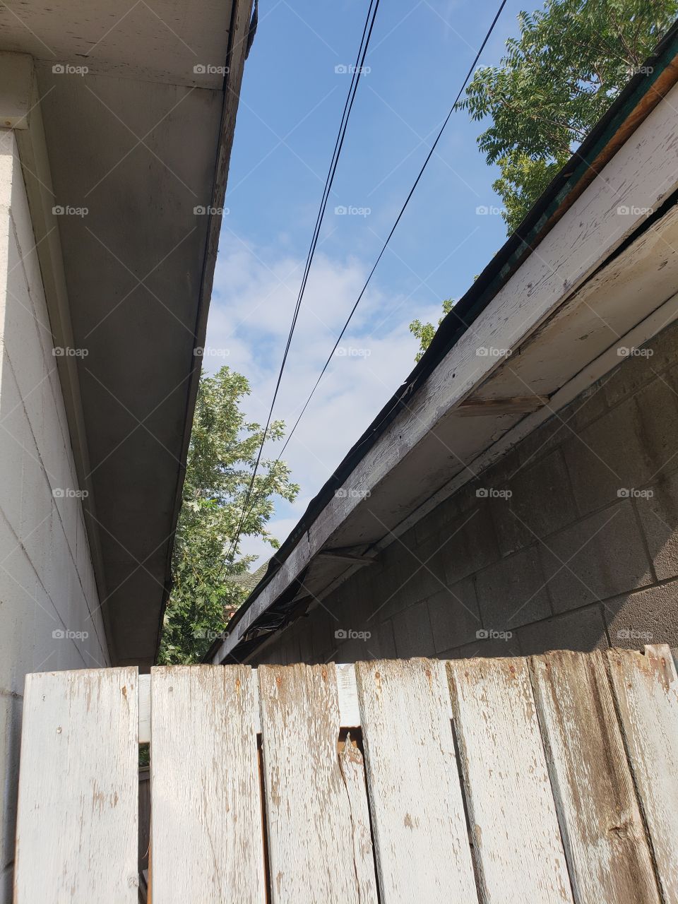 roof line Eaves between two buildings with top offense and Sky visible