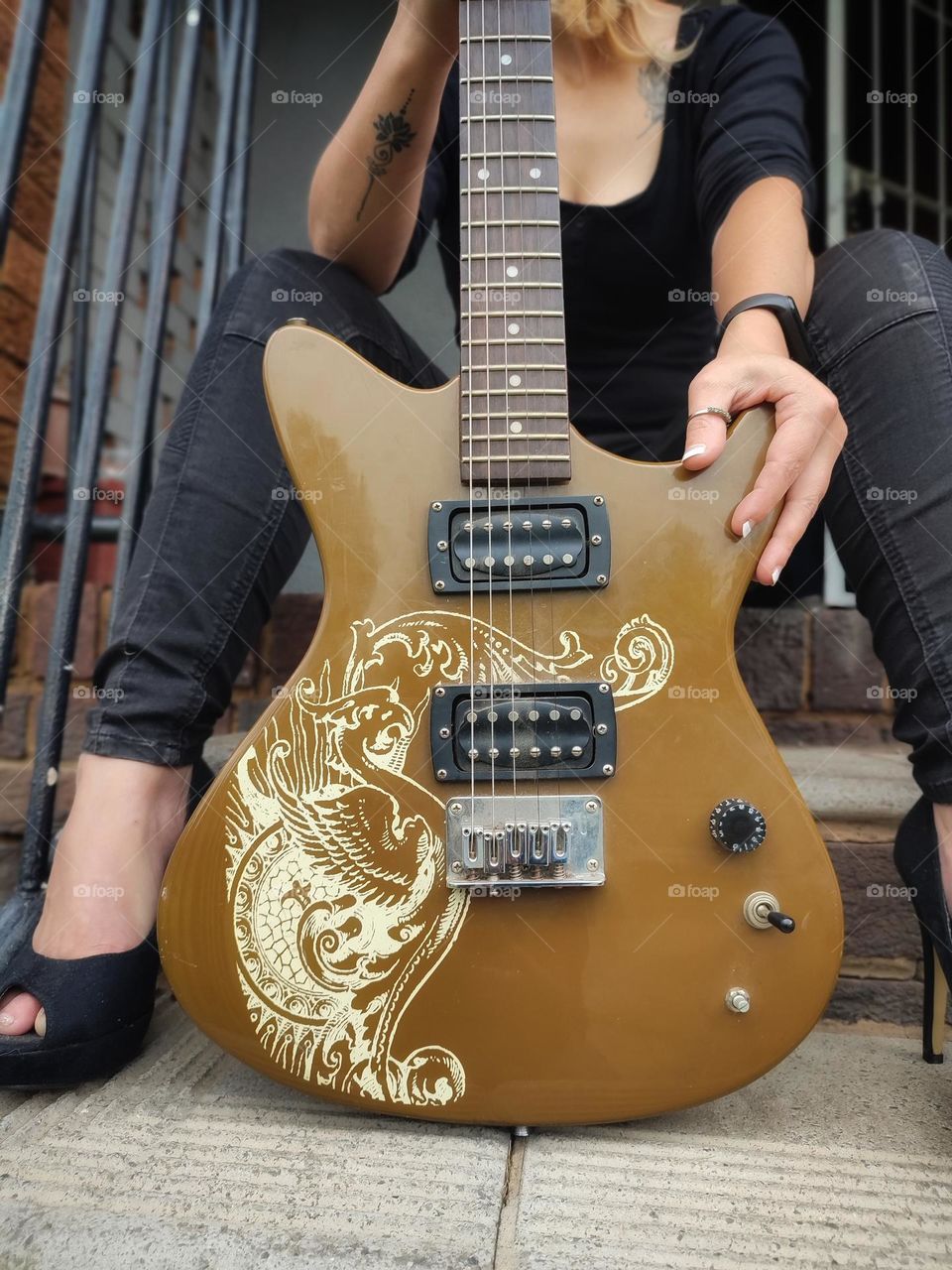 Female sitting with Electric Guitar