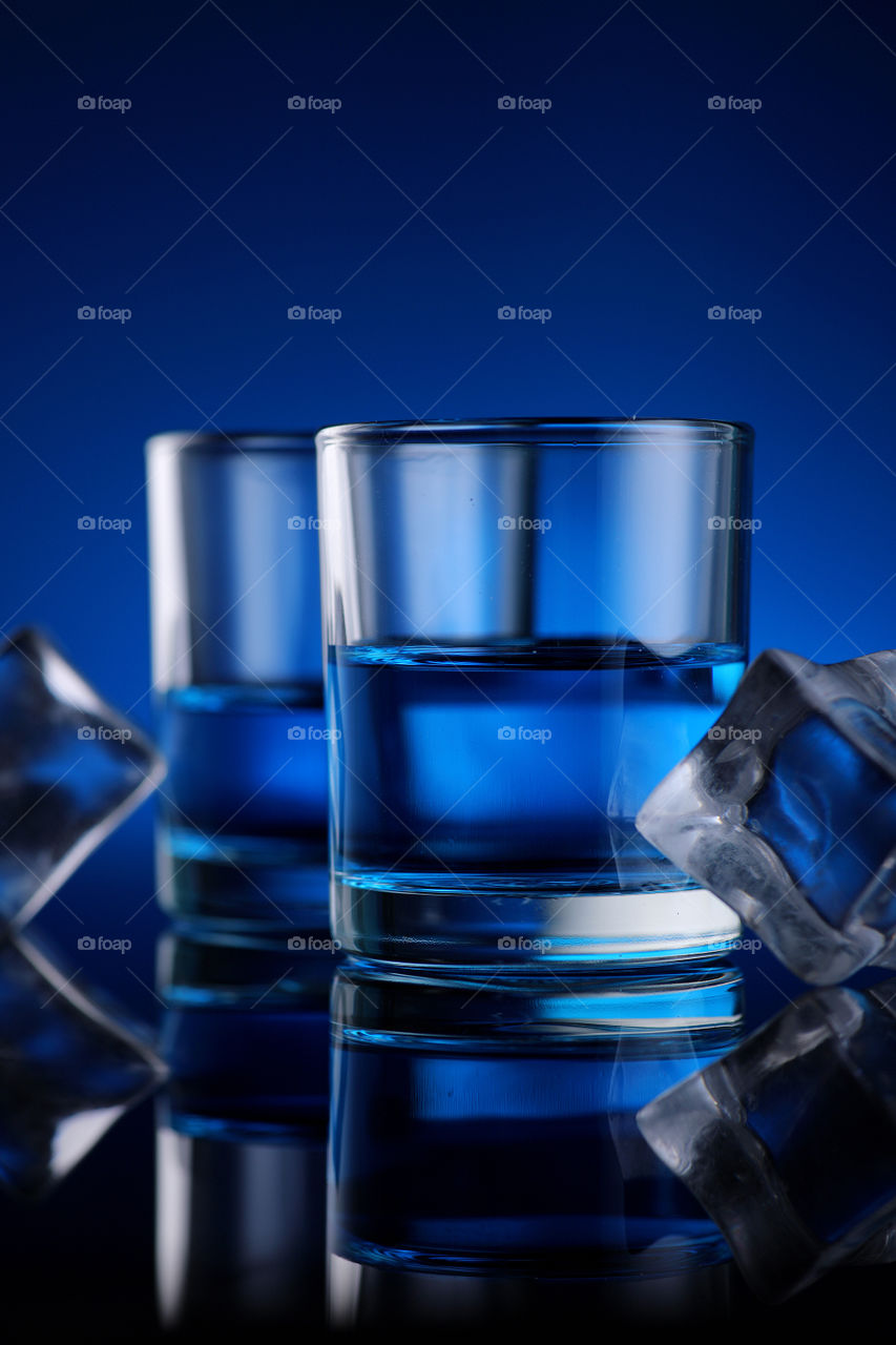 two glasses with blue drink