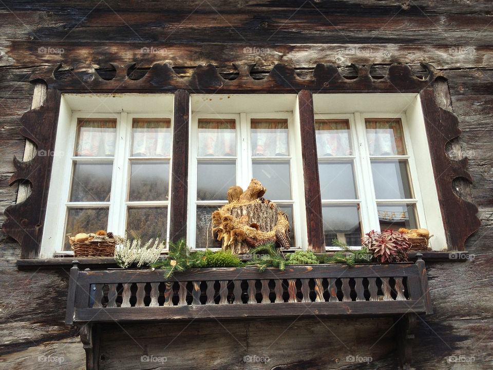 typical old chalet from 1800 windows and décoration in front of window zermatt by swisstraveler