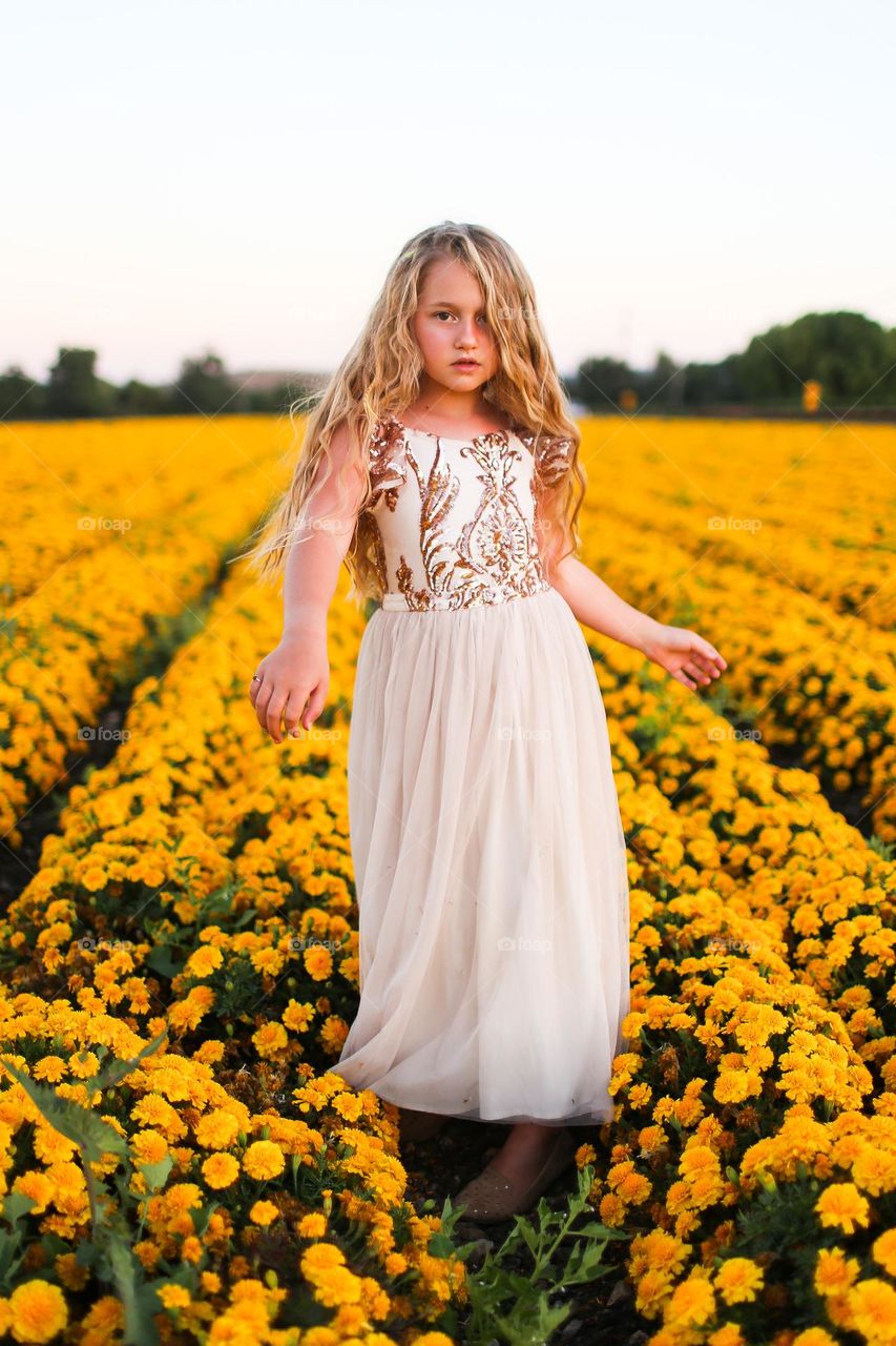 Girl in a flower yellow field