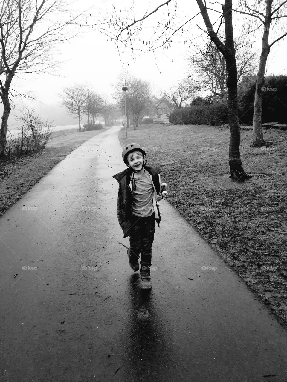 Boy with skateboard walking