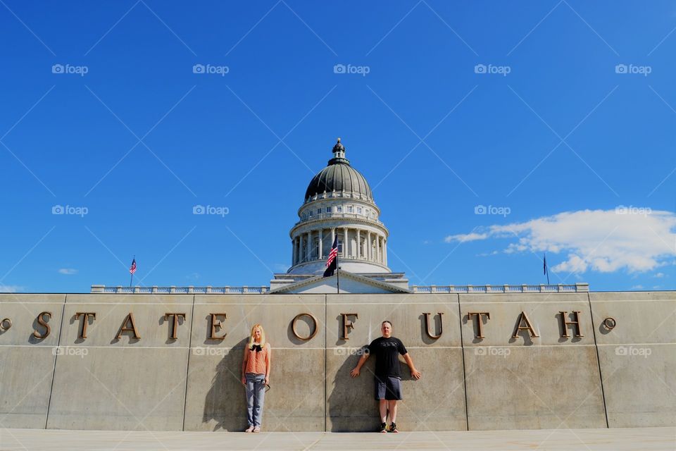 Two people standing in front of state capitol in Utah 