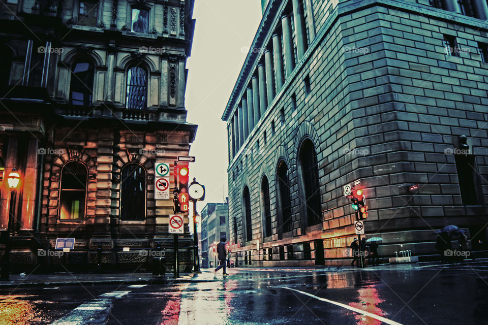 City of Montreal Old Port Historic district in the rain with reflections of streetlights on pavement 