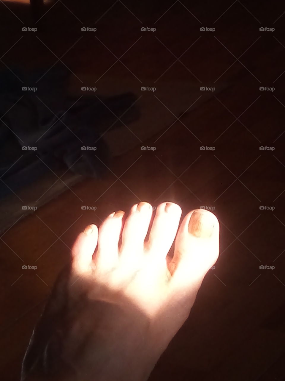 as the sun begins to set it is shining  in bright on my toes. a reminder of the beautiful day.