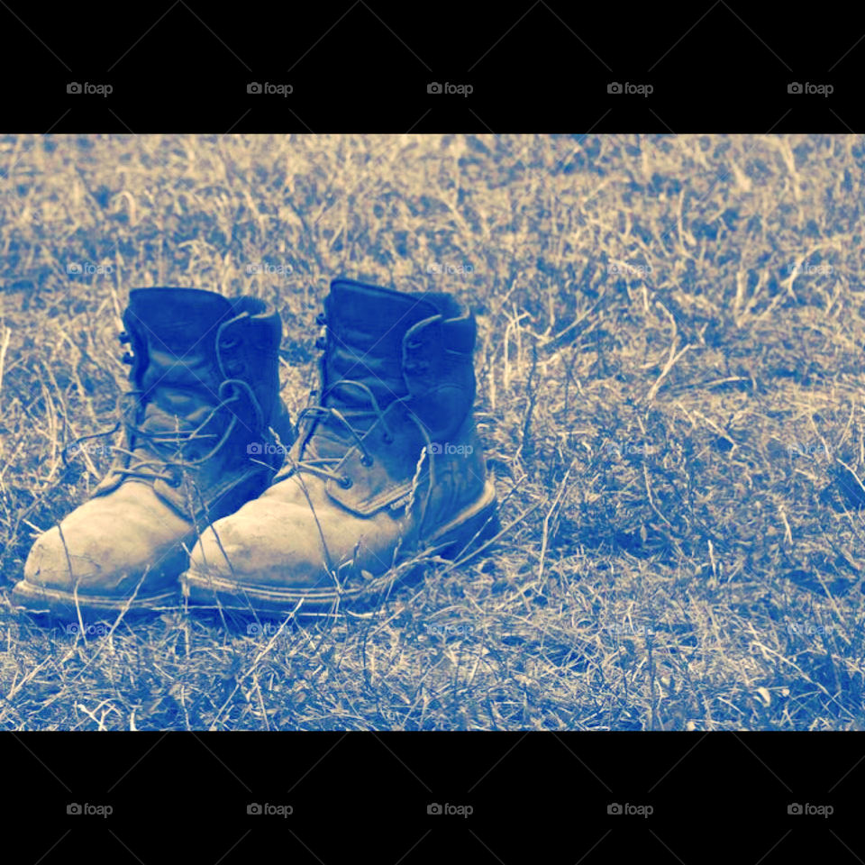 Hard hard worker . A union workers boots in a field 