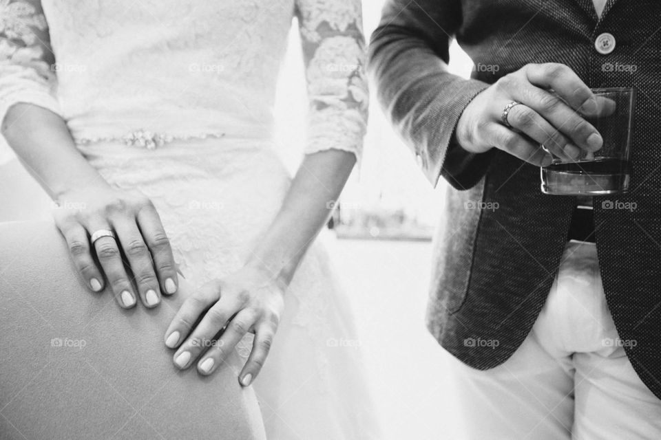 A just married couple's hands with wedding rings 