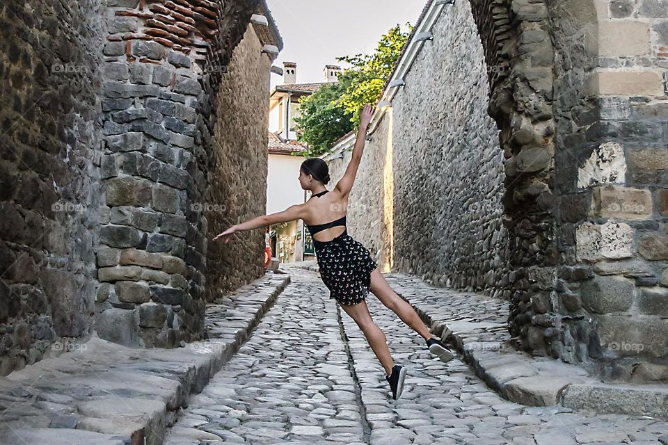 Young Female Ballerina Dancing Outside