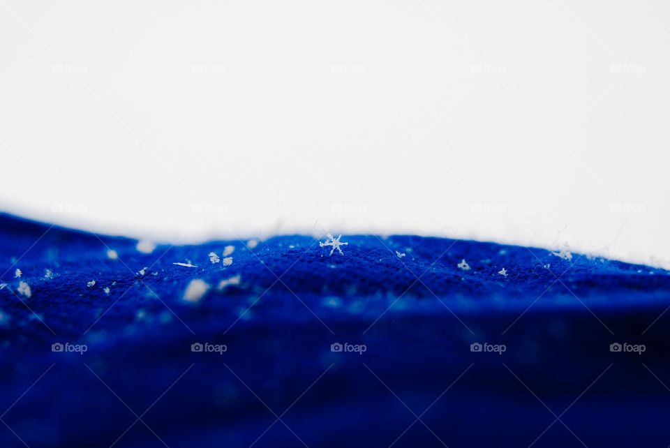 A unique snowflake with a blue backdrop. 