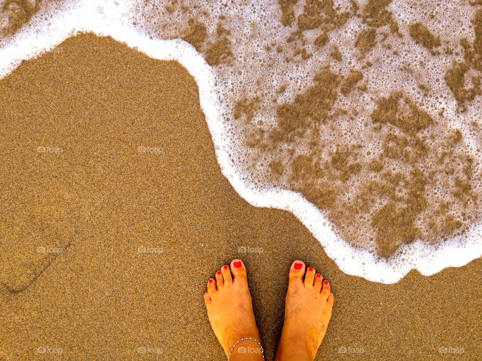 Woman's feet on sand at beach