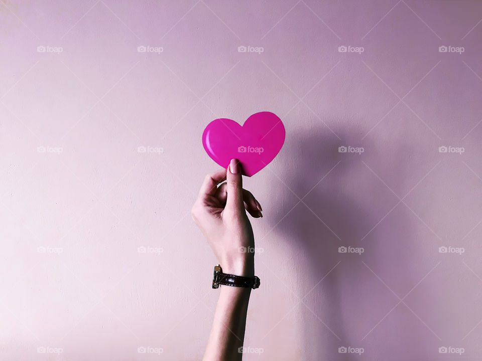 Pink heart in hand 