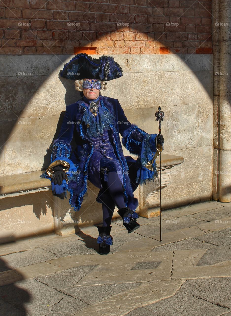 Man posing in his costume under the Doge's Palace, Venice