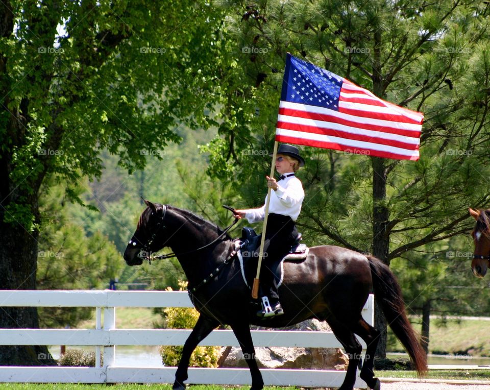 Equestrian carries the American Flag 