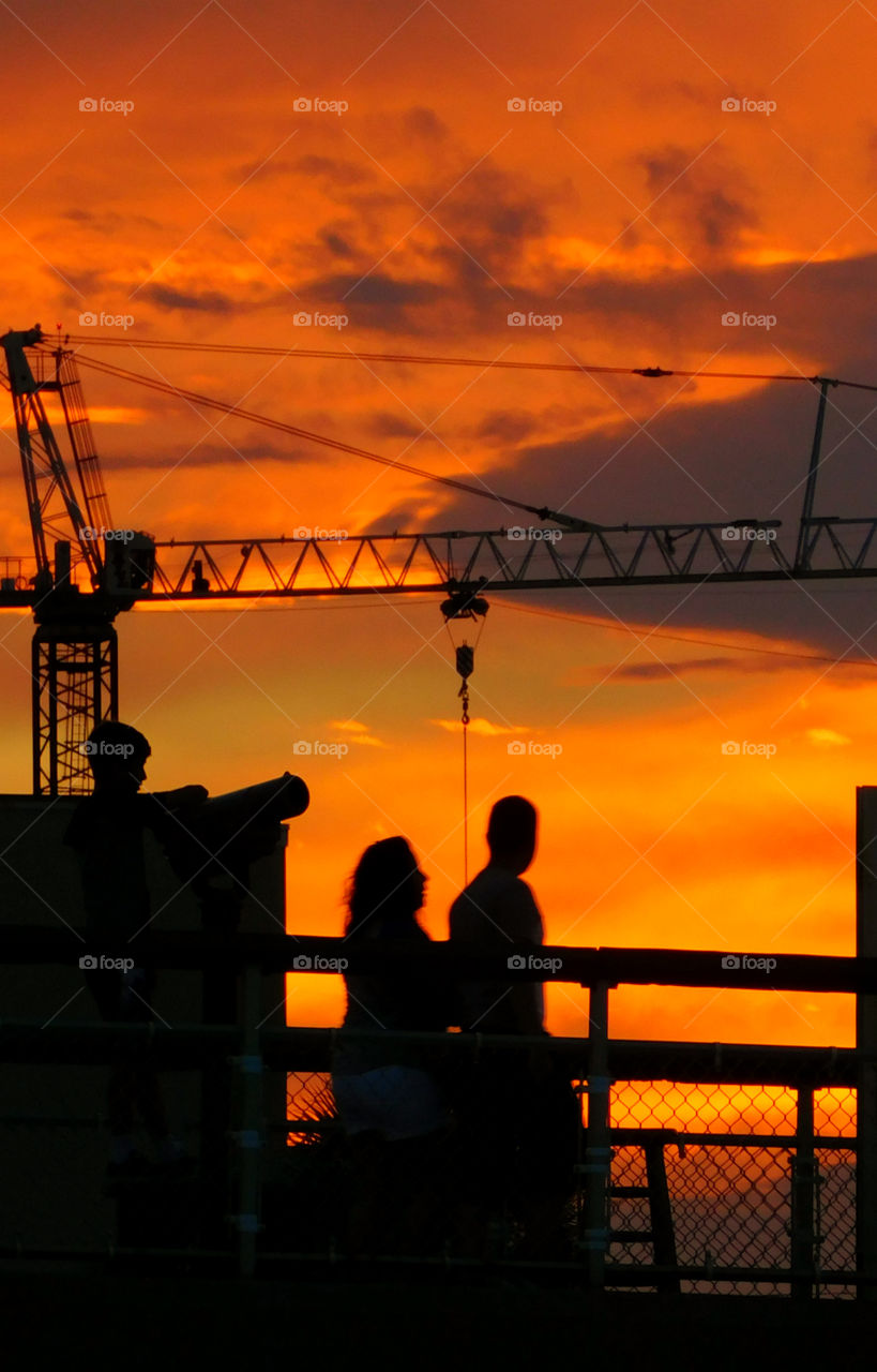 People strolling across the pier to catch a glimpse of this spectacular sunset over the Gulf of Mexico!