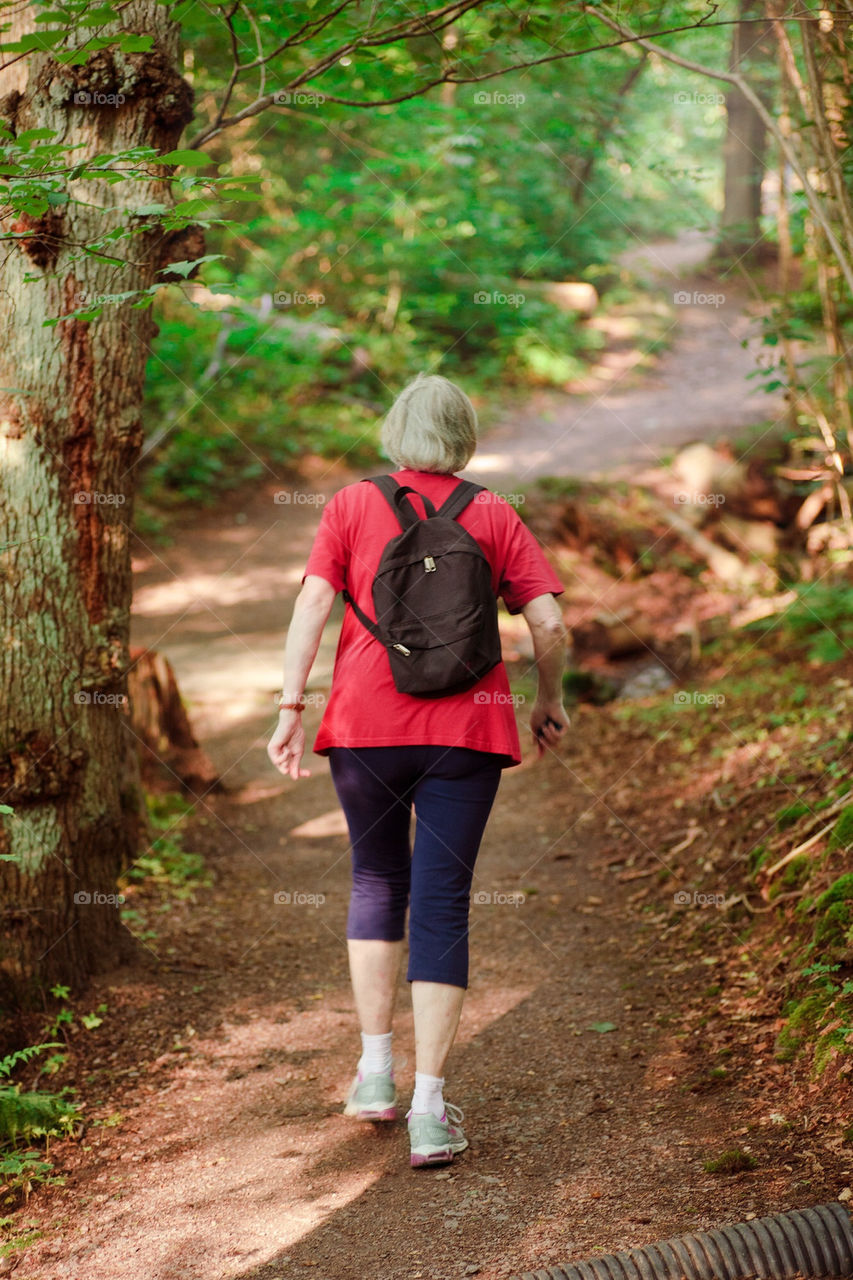 Elderly woman walking in the forest