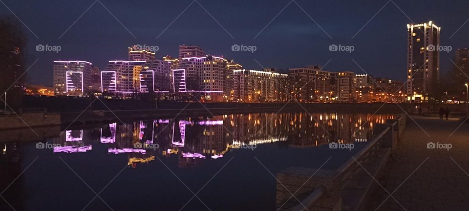 beautiful night light street view, windows magic light, cityscape and reflection in water