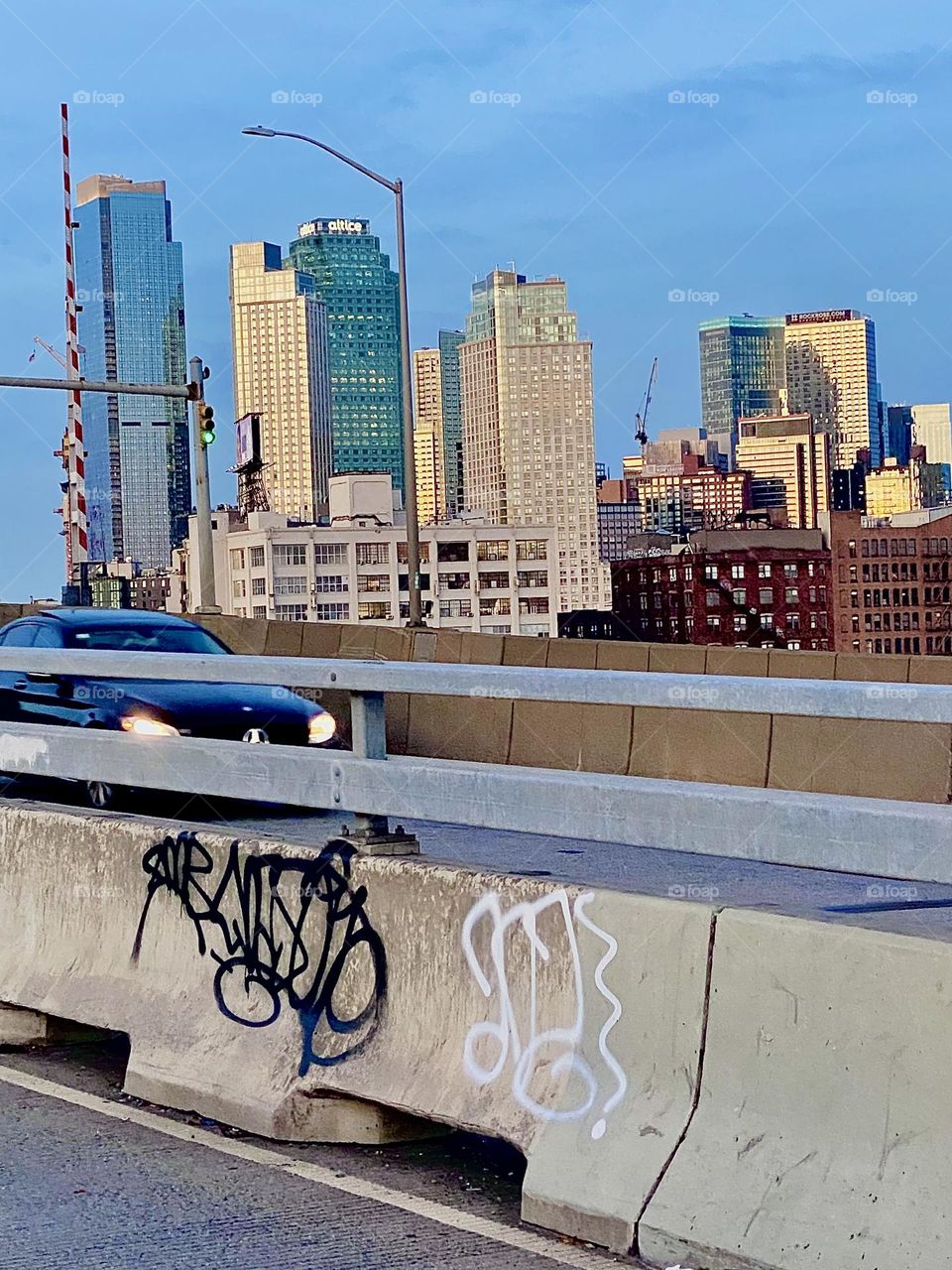 This is the LIC skyline seen from the pedestrian lane of the “Pulaski Bridge” at “Newtown Creek” during the golden hour of sunset on a gorgeous Indian summer day in early October 2023. Hypnotic Productions