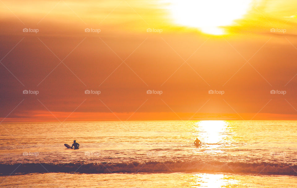 Sunset and surfers