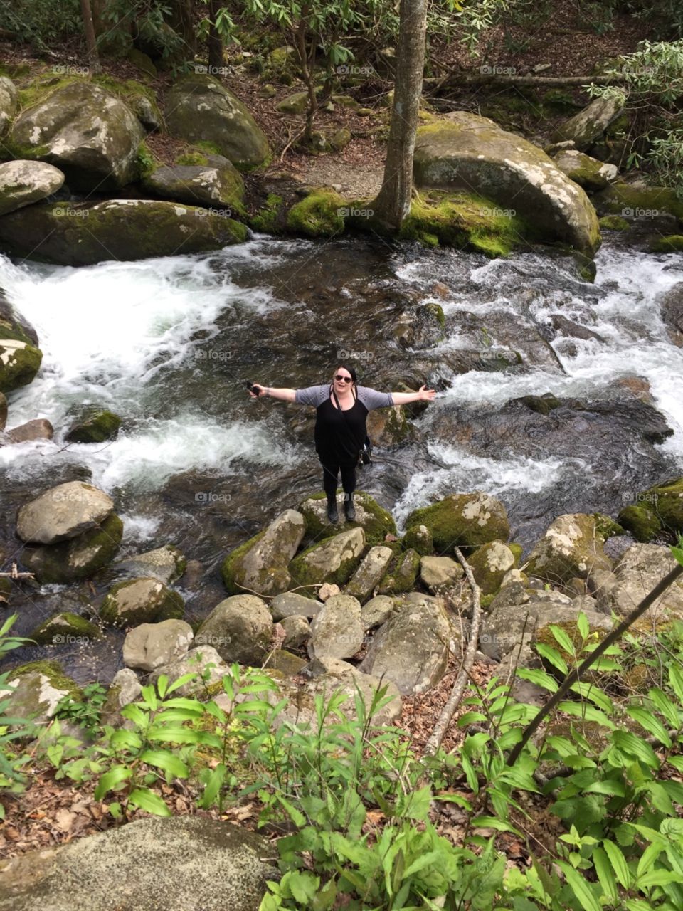 happy person hiking near water rapids