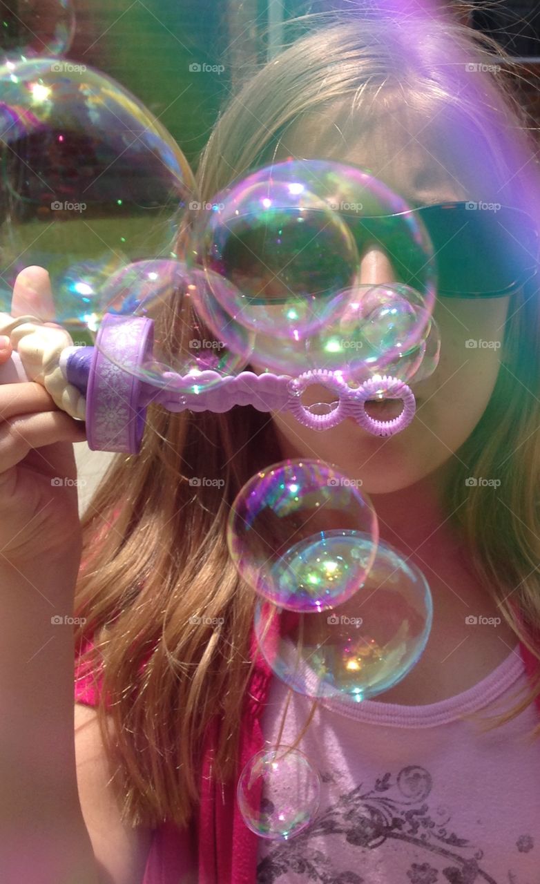 Bubbles. Girl blowing bubbles