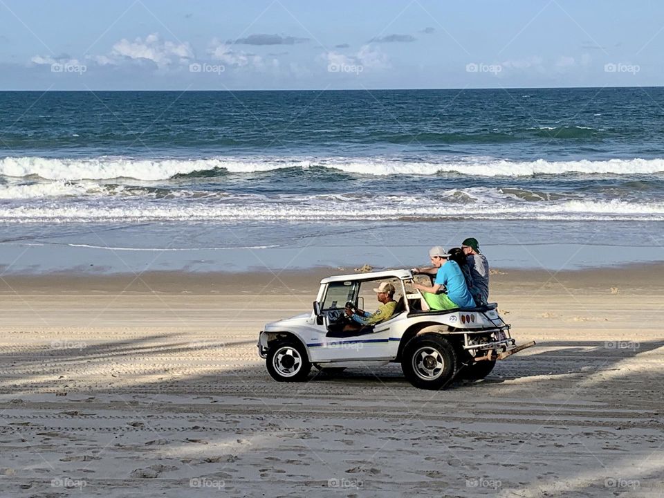 Family riding a buggy on the beach