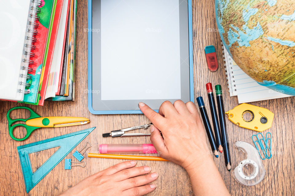 Elevated view of stationery with tablet