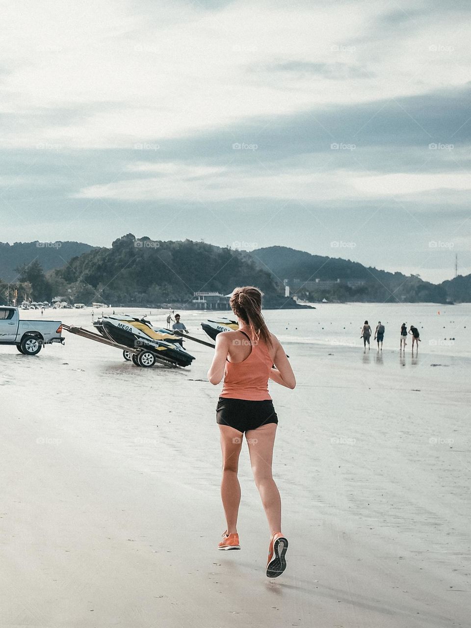 A lady doing her routine beach run