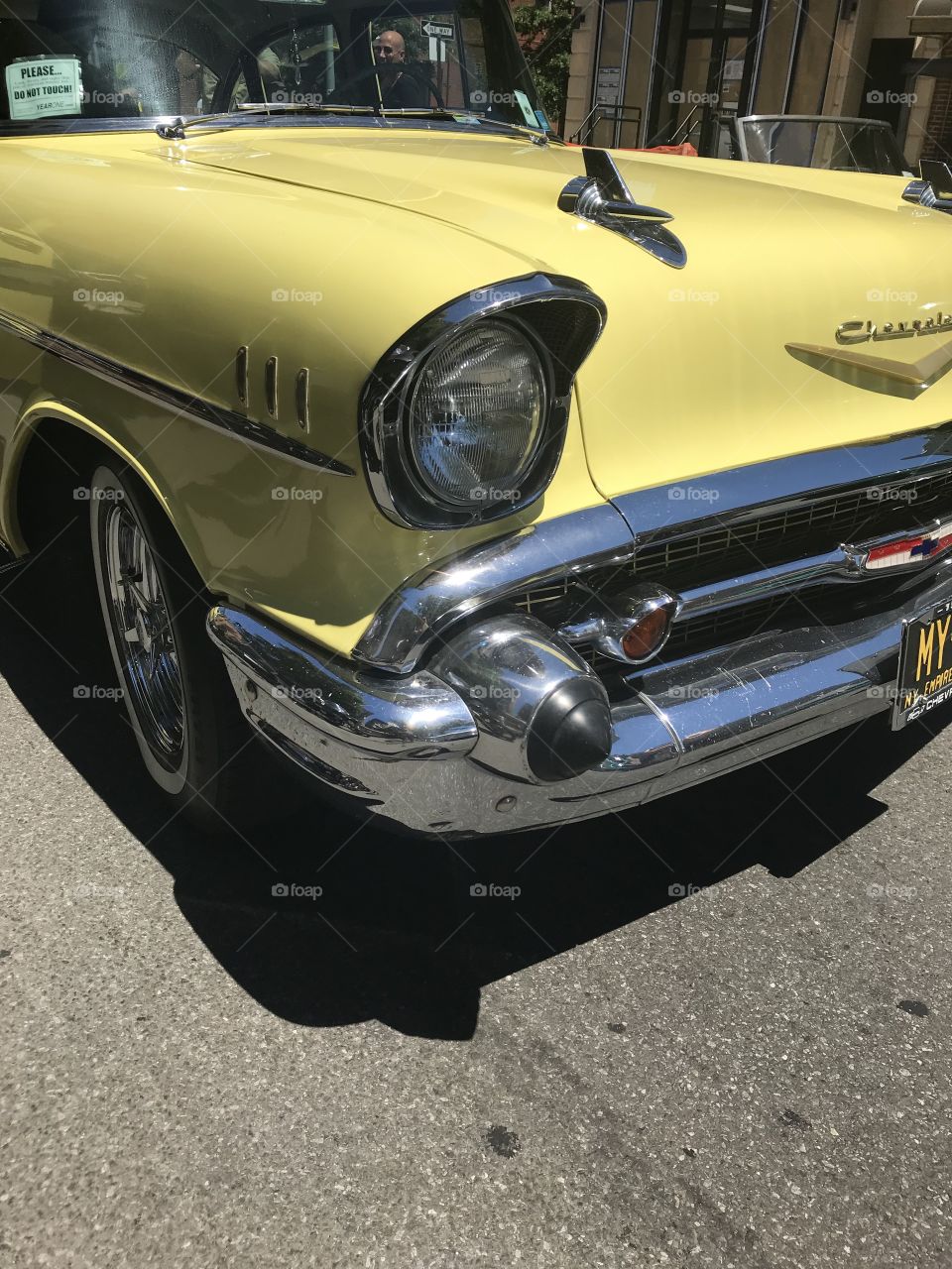 Yellow vintage car headlight and grill close up 