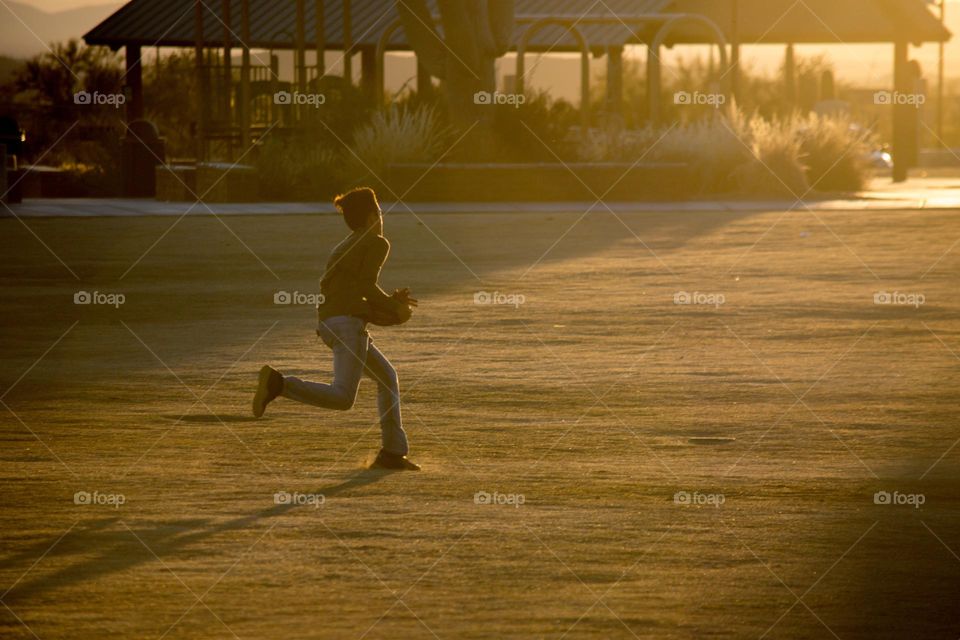 A kid running and catching a ball