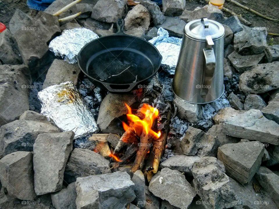 camp fire cooking. making breakfast on a camping trip