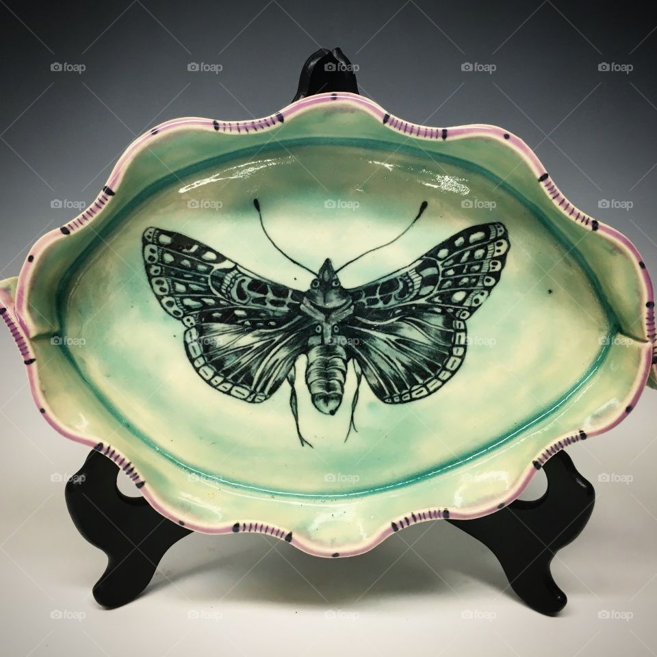 Custom, hand-built plate with moth painted on with underglaze.
