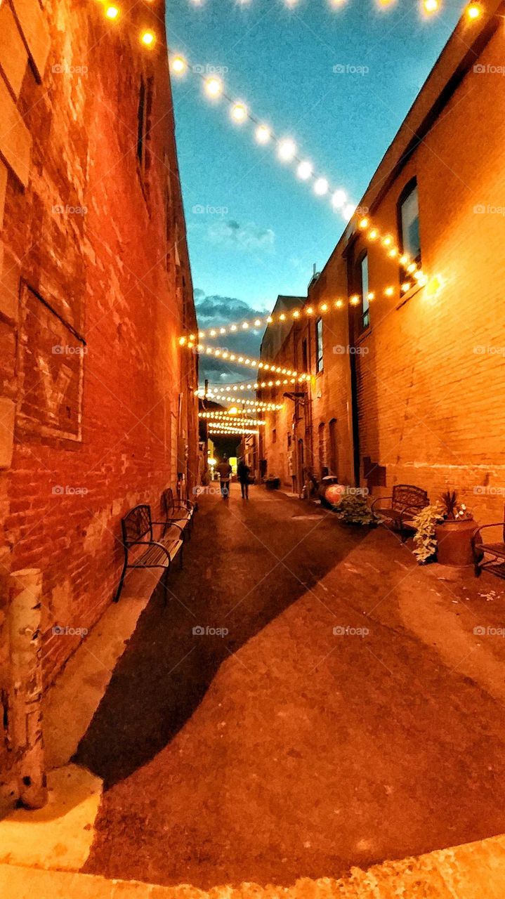 Long neglected, this downtown alley got a facelift and glows brightly on a warm summer evening.