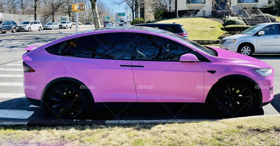 Pretty in pink-a Tesla model in a pretty pink shade, and very eye catching. 